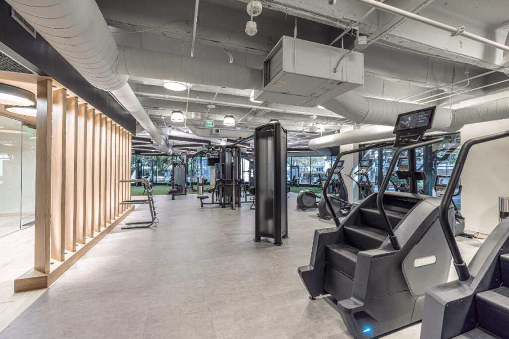 Park West Fitness boasts a modern interior with exercise machines, treadmills, and weights, all in a bright and spacious layout.